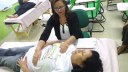 Silvana Machado aplica a terapia Jin Shin Jyutsu em uma das participantes do Saúde na escola